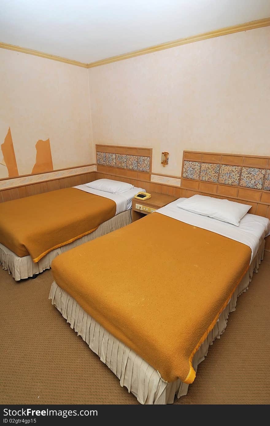 Twin beds neatly done up in a high class hotel room. Suitable for concepts such as travel, tourism, vacation and holiday. Twin beds neatly done up in a high class hotel room. Suitable for concepts such as travel, tourism, vacation and holiday.