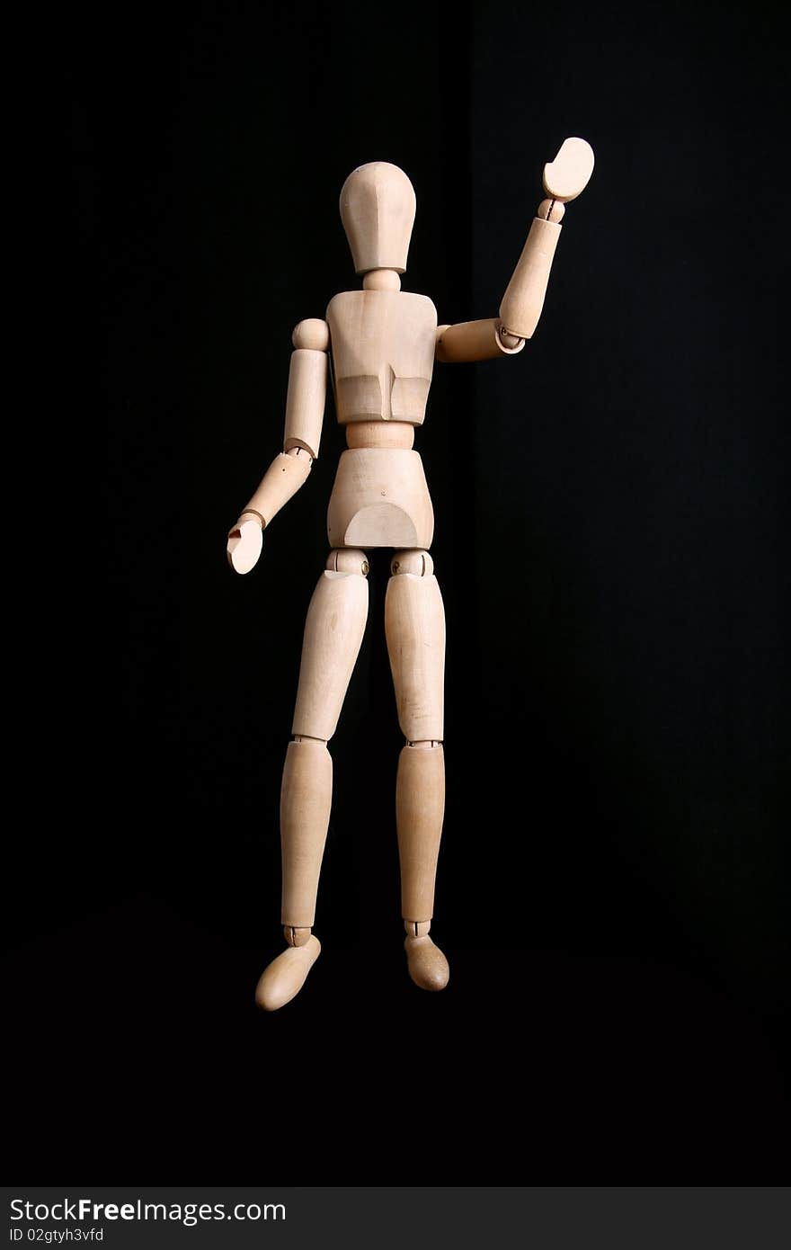 A manikin saying goodbye on a black background