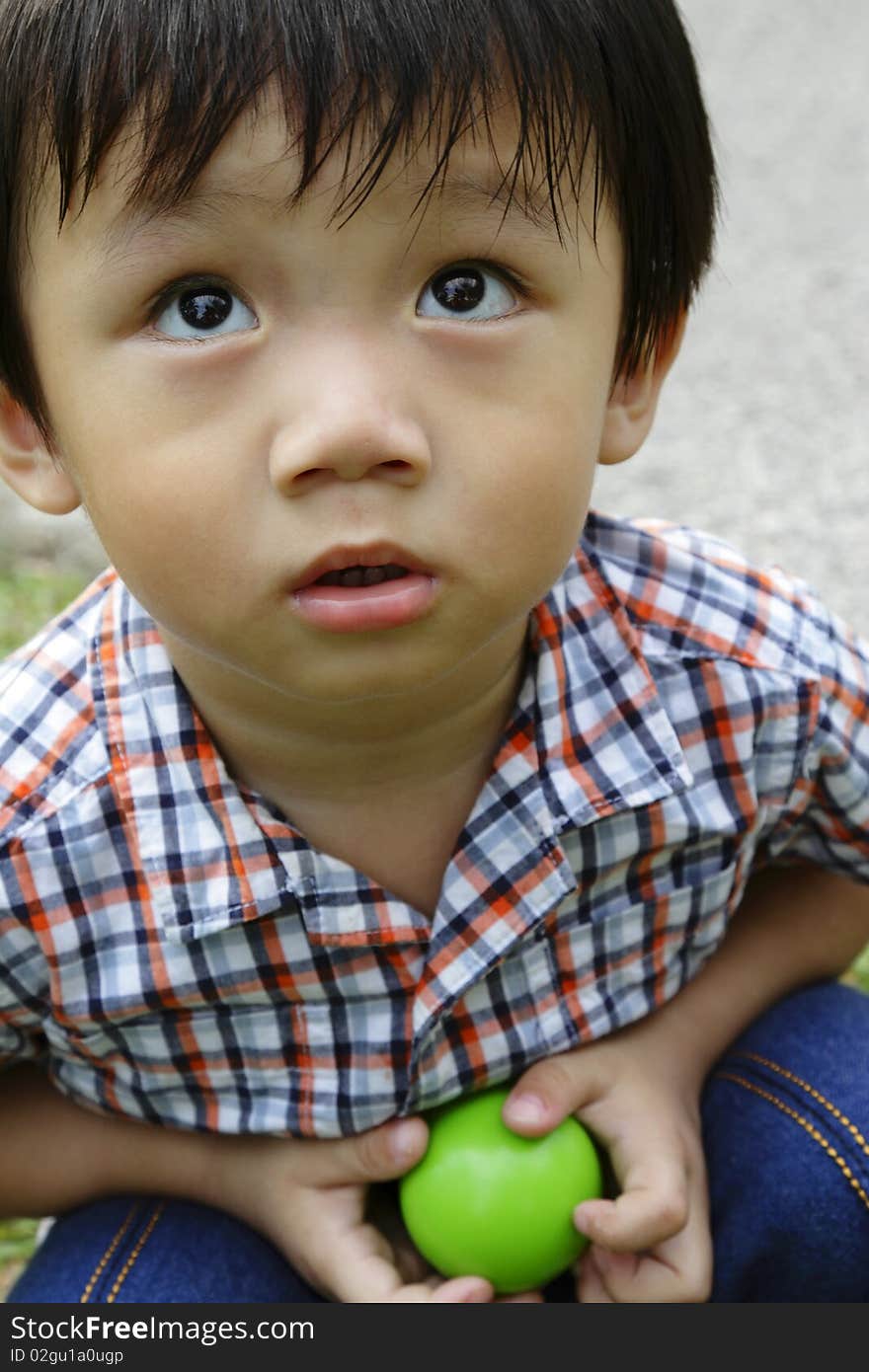 Portrait of a young Asian boy playing at a park