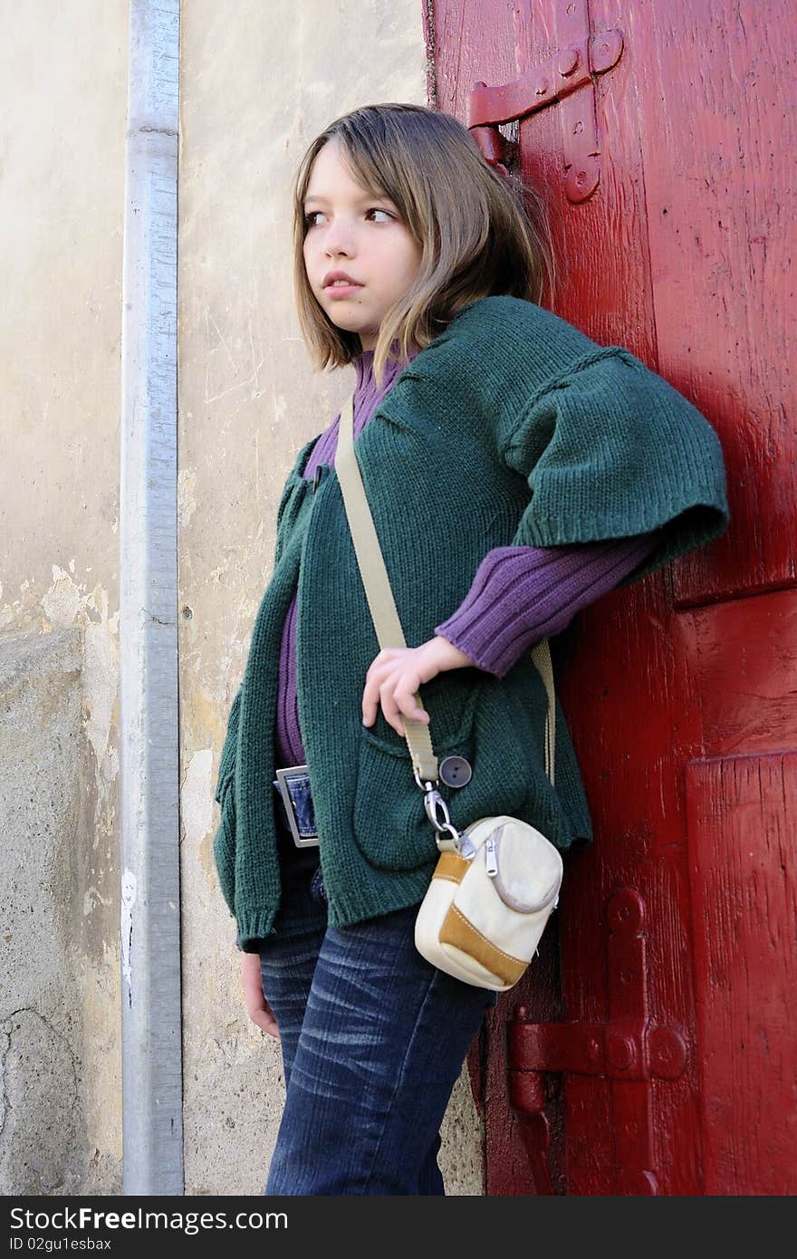 Lovely girl posing with red door in background