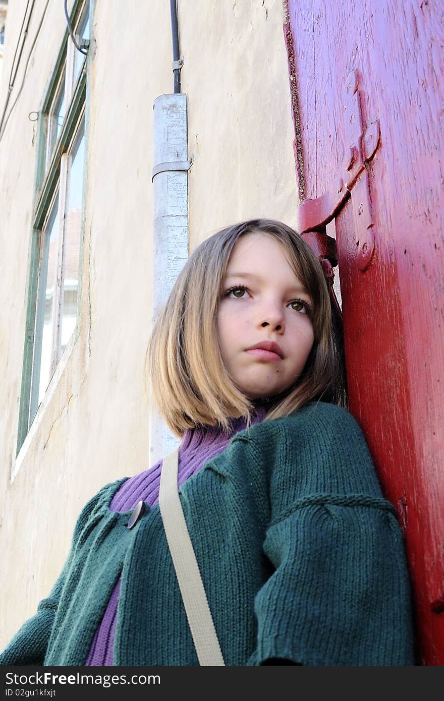 Lovely girl posing with red door in background