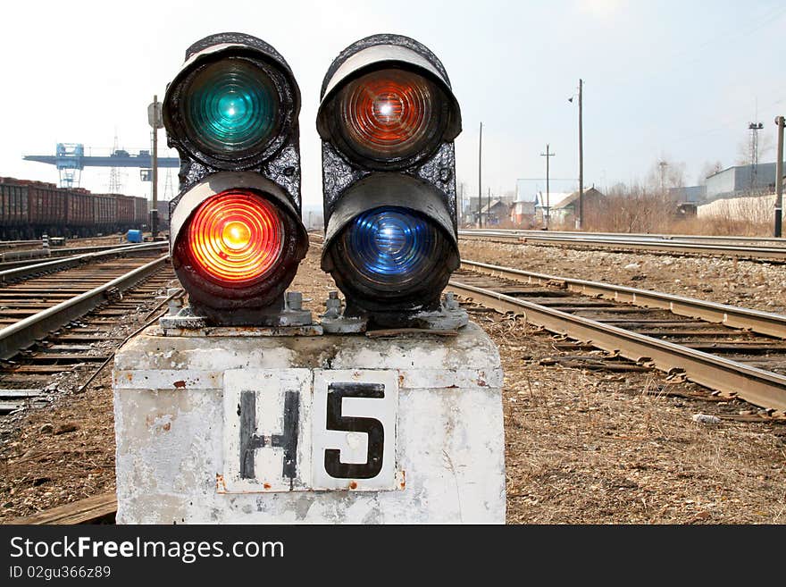 Railway traffic light burns four colors. Railway traffic light burns four colors