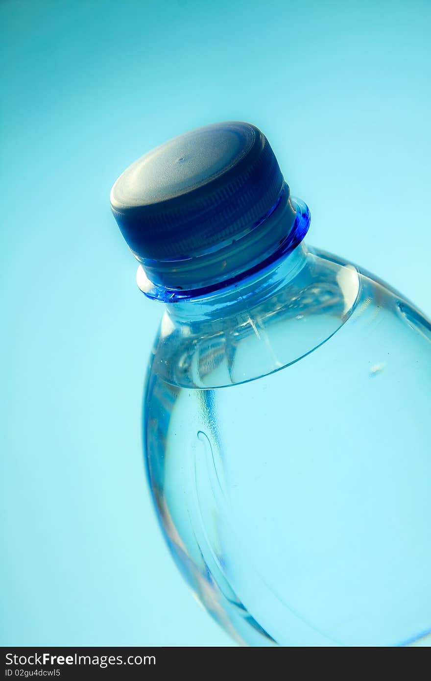 A plastic bottle filled with still water. Image isolated on light blue studio background.
Focus on bottle cap. A plastic bottle filled with still water. Image isolated on light blue studio background.
Focus on bottle cap