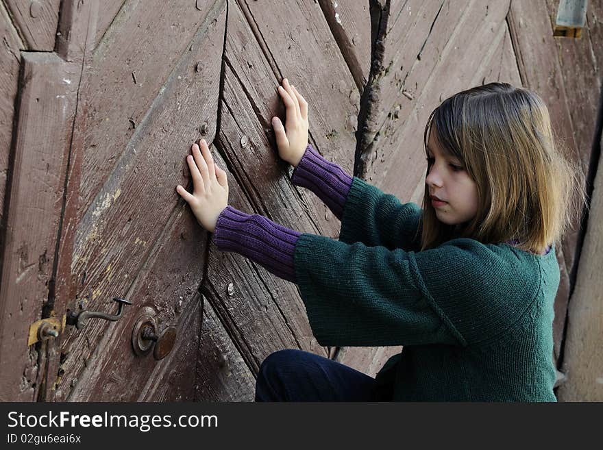 Lovely child opening museum door and thinking. Lovely child opening museum door and thinking