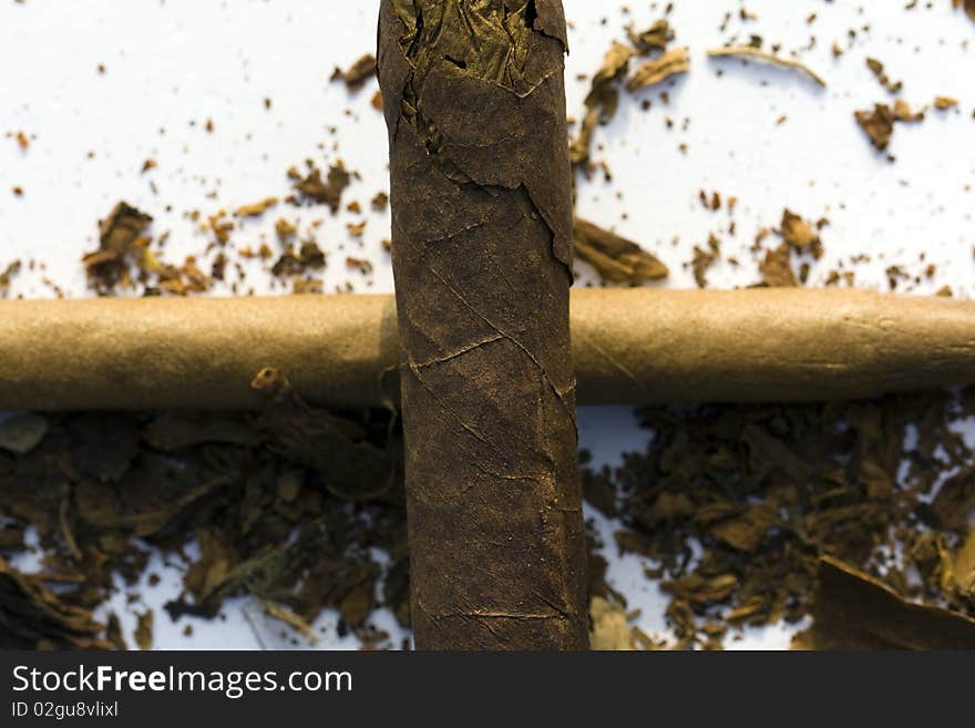 Cross from cigars with the tobacco scattered around. Cross from cigars with the tobacco scattered around