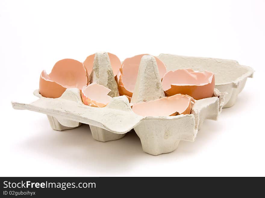 A collection of broken egg shells in cardboard egg box concept.