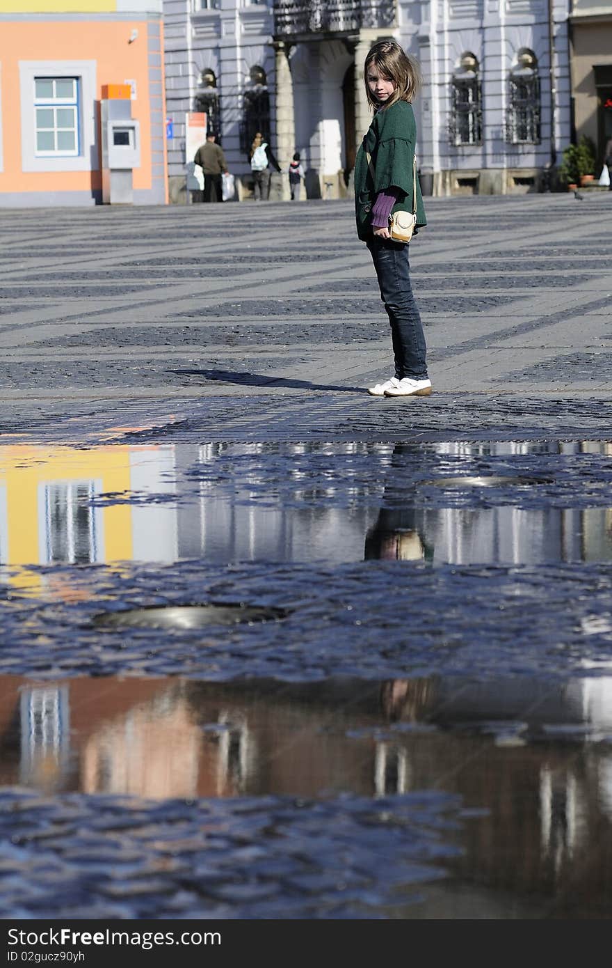 White child reflections in city square