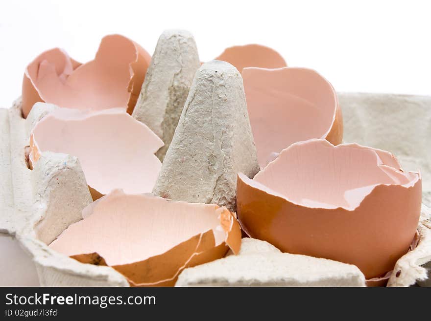 A collection of broken egg shells in cardboard egg box concept.