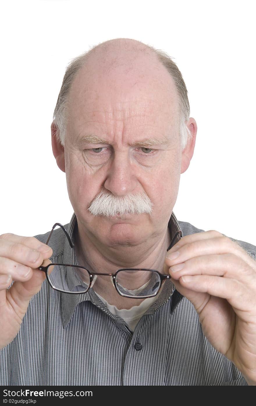 Man looking at his glasses. Man looking at his glasses