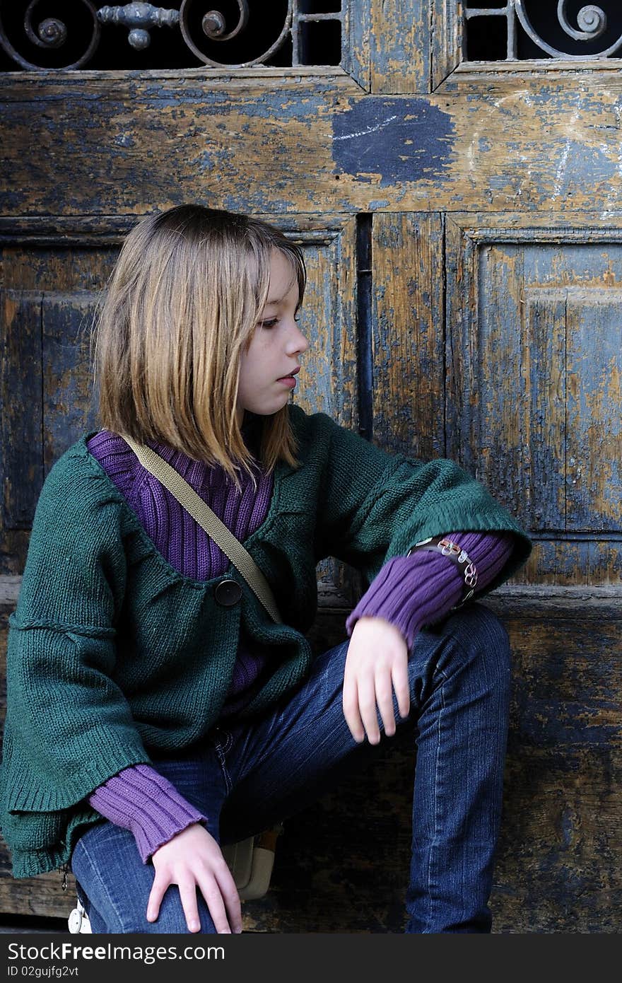 One child portrait with old door in background. One child portrait with old door in background