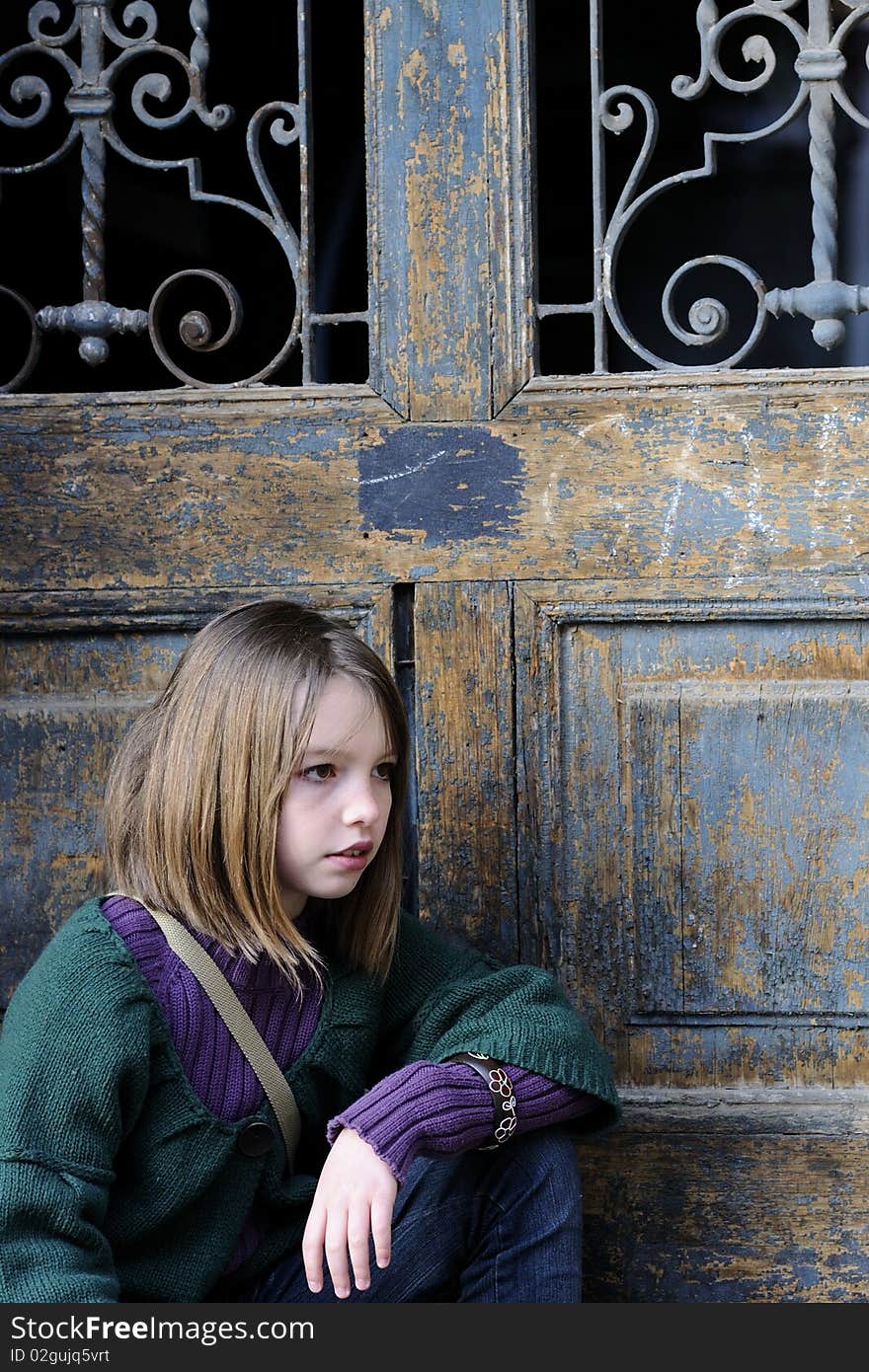 One child portrait with old door in background. One child portrait with old door in background