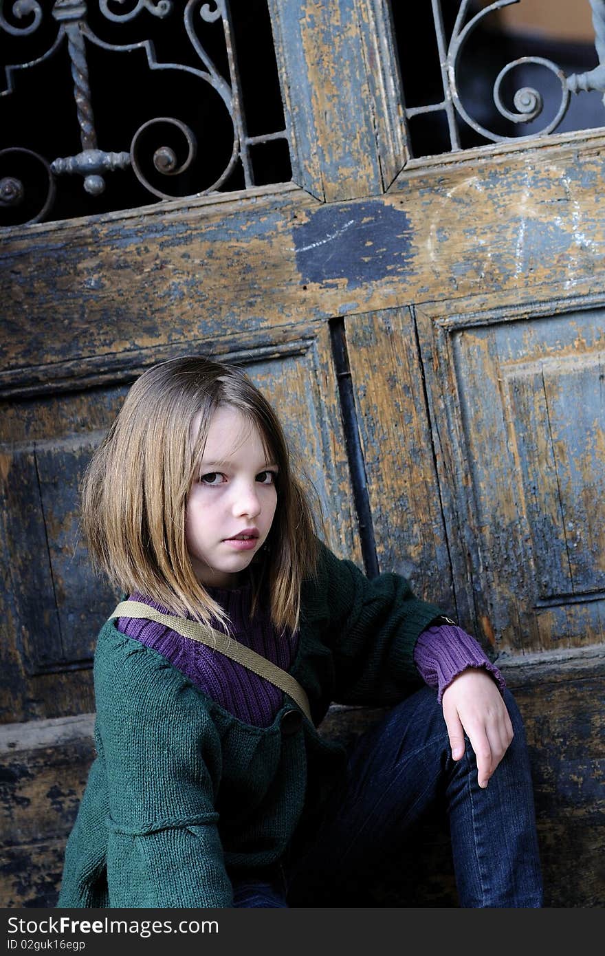 One child portrait with old door in background. One child portrait with old door in background