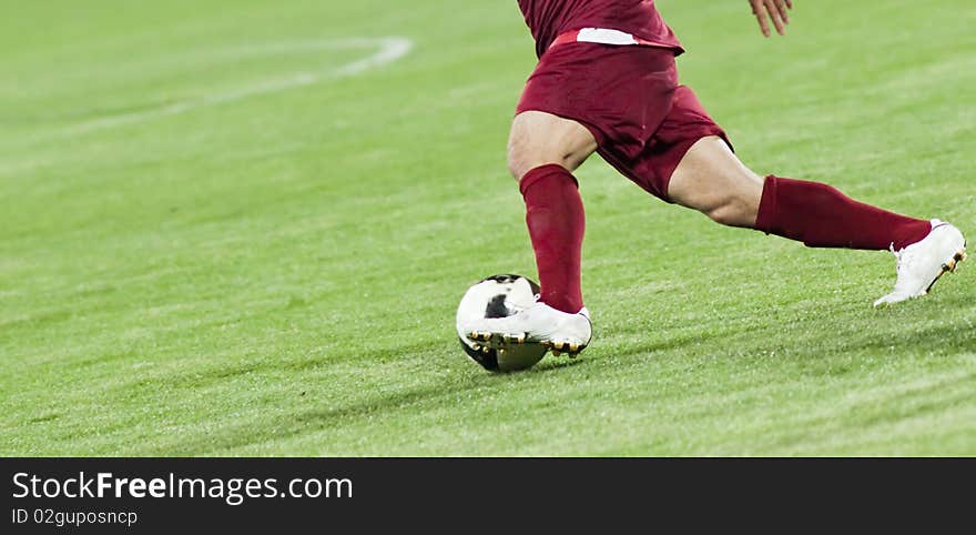 Soccer players running after the ball