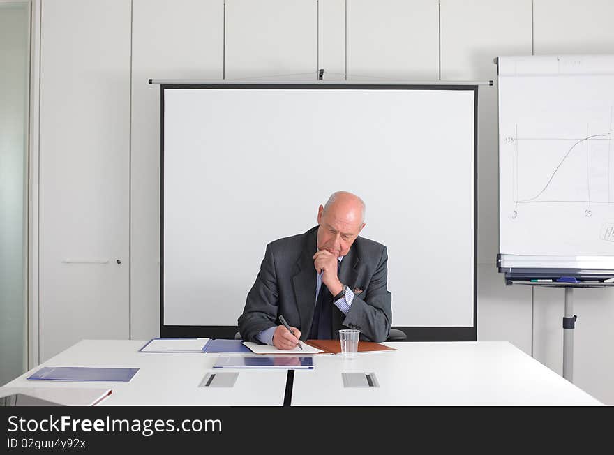 Senior businessman sitting and working