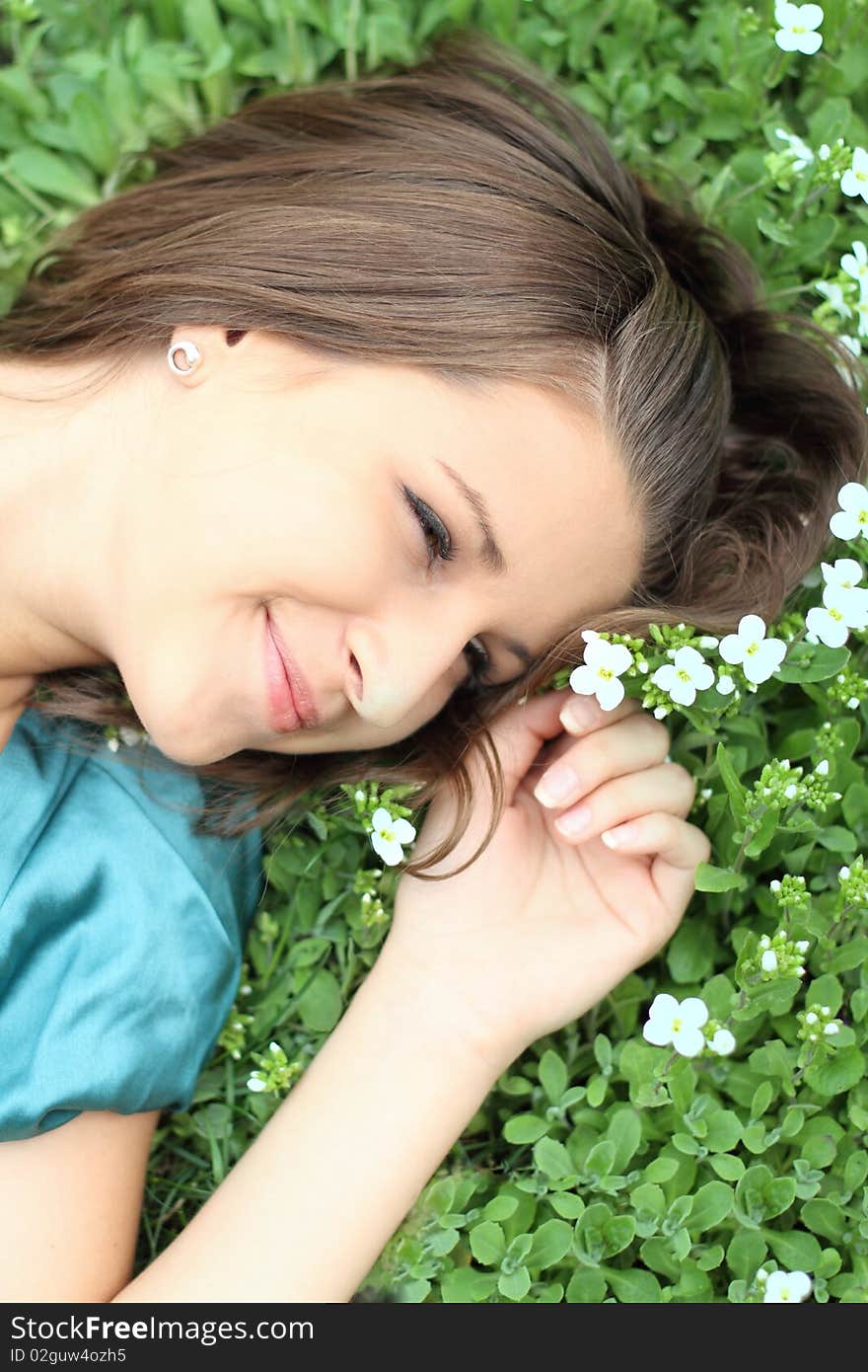 Portrait of the young girl on the flower background. Portrait of the young girl on the flower background