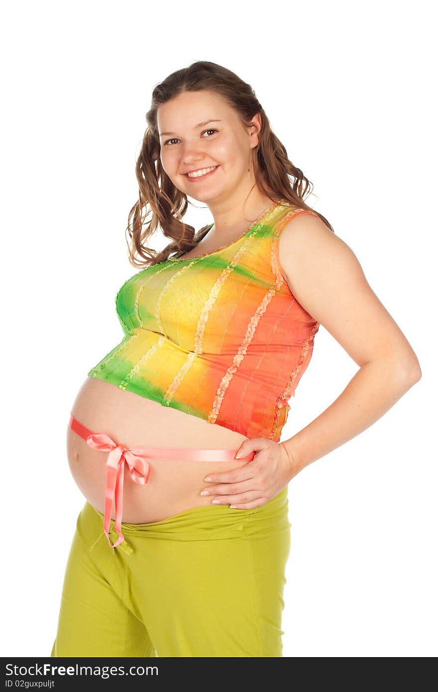 Pregnant beautiful smiling woman in a in green trousers and a colored shirt with a pink ribbon on the belly. Pregnant beautiful smiling woman in a in green trousers and a colored shirt with a pink ribbon on the belly.