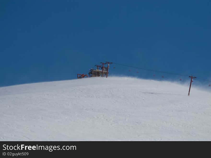 A photo of a ski lift on a cold, windy day near Anchorage, Alaska. It was a bright sunny day with a blue sky background. A photo of a ski lift on a cold, windy day near Anchorage, Alaska. It was a bright sunny day with a blue sky background.