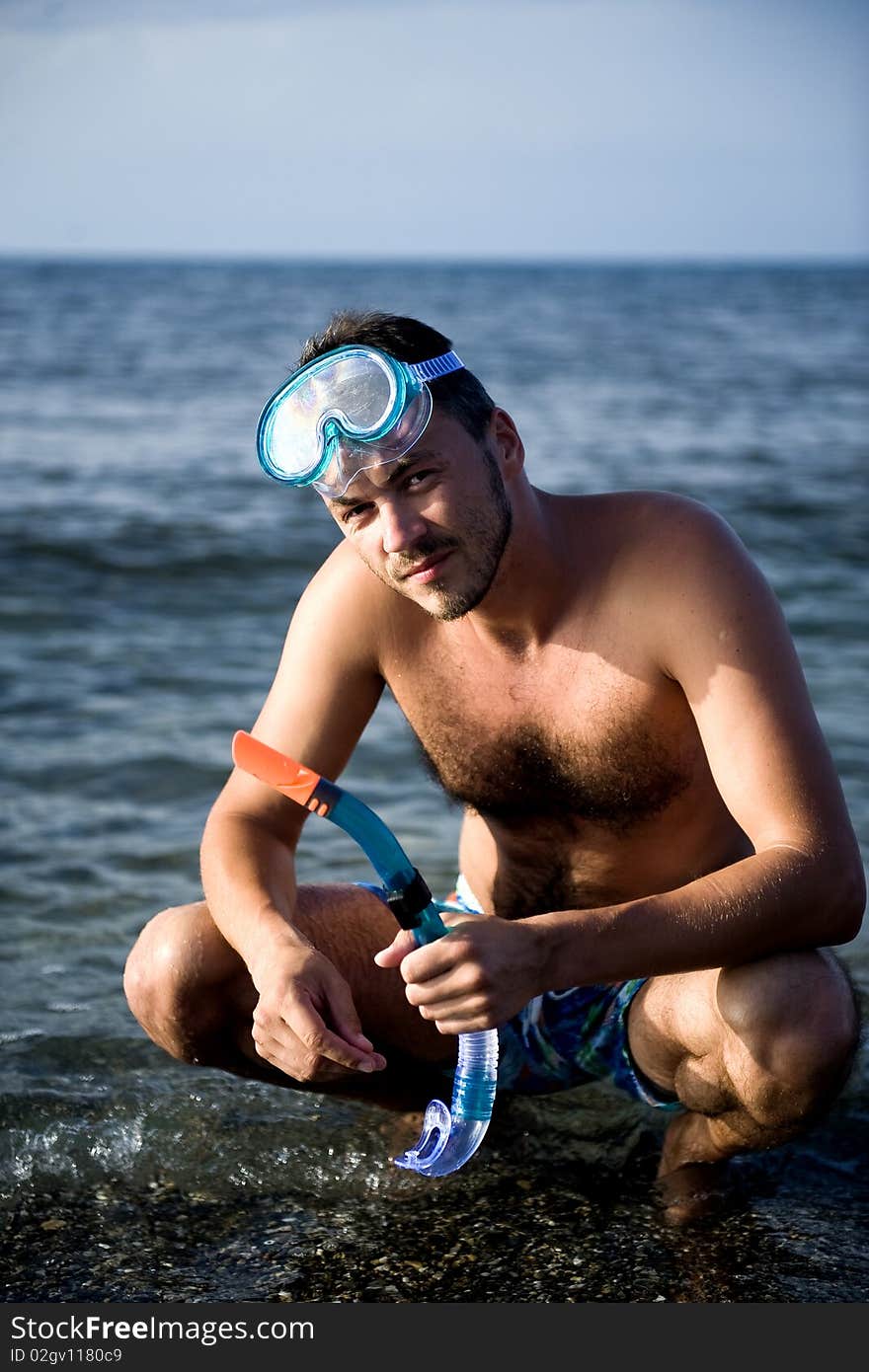 Young summer diving man with swimming mask