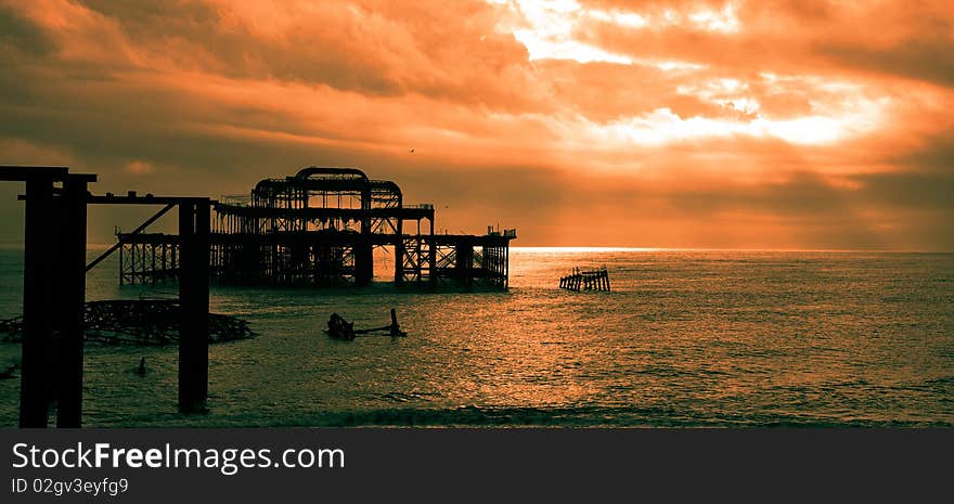 Old part of the brighton bridge, which been burned and left in the beach. Old part of the brighton bridge, which been burned and left in the beach