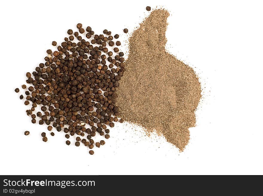 Ground and grains of black pepper