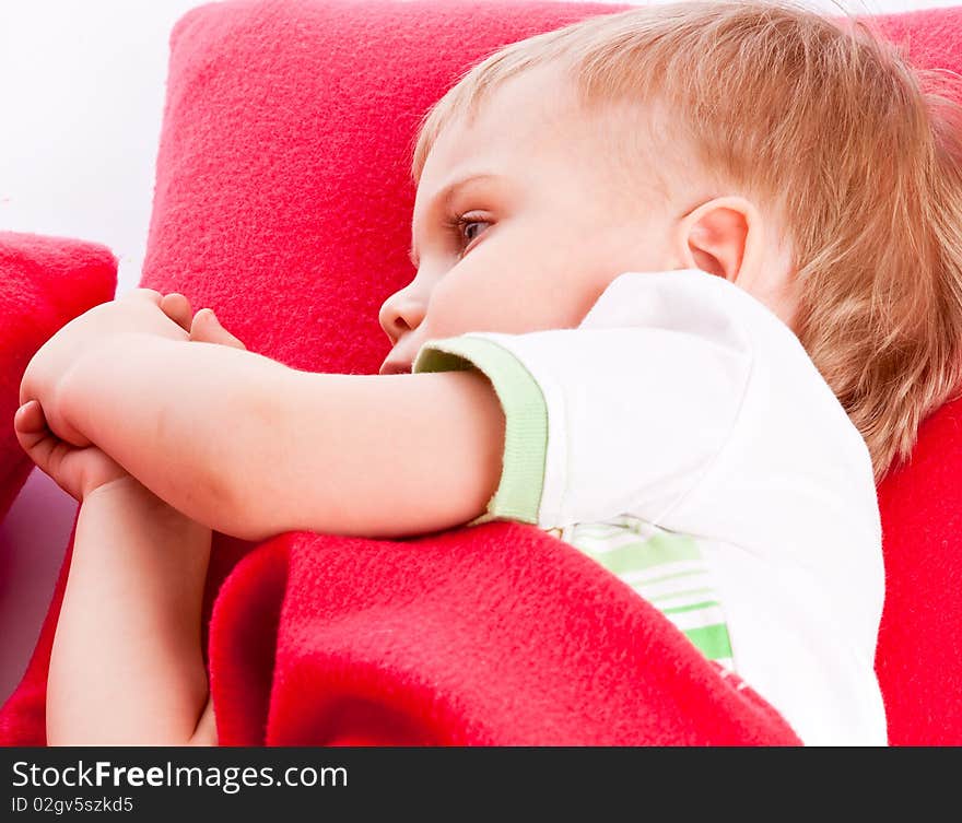 Little boy is sleeping on a red pillow. Little boy is sleeping on a red pillow