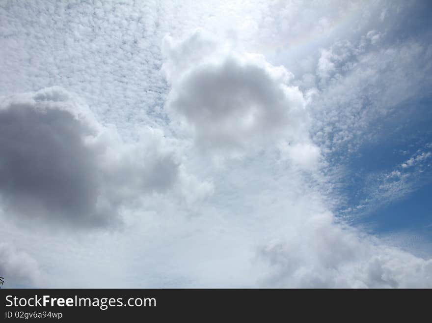 A photo of clouds where lights are emerging out from the back of the clouds. A photo of clouds where lights are emerging out from the back of the clouds.