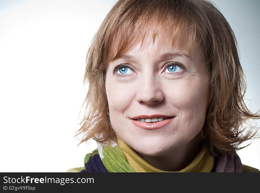 Portrait of a blue-eyed woman in a pale green sweater