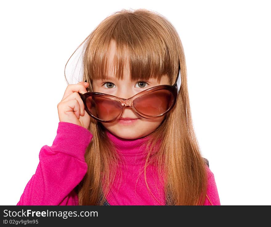 Little girl looks over dark glasses isolated on white