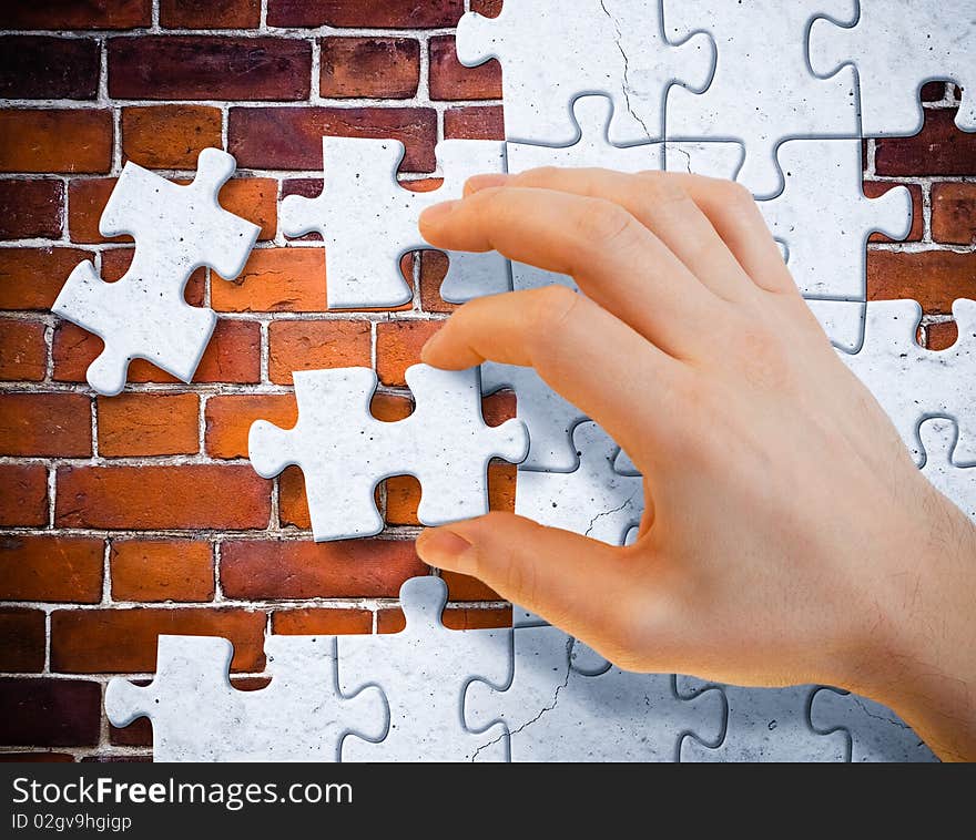 Hand With Stucco Puzzle Pieces