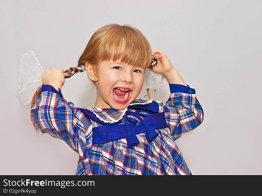 Little girl shouts keeping for plaits. Little girl shouts keeping for plaits