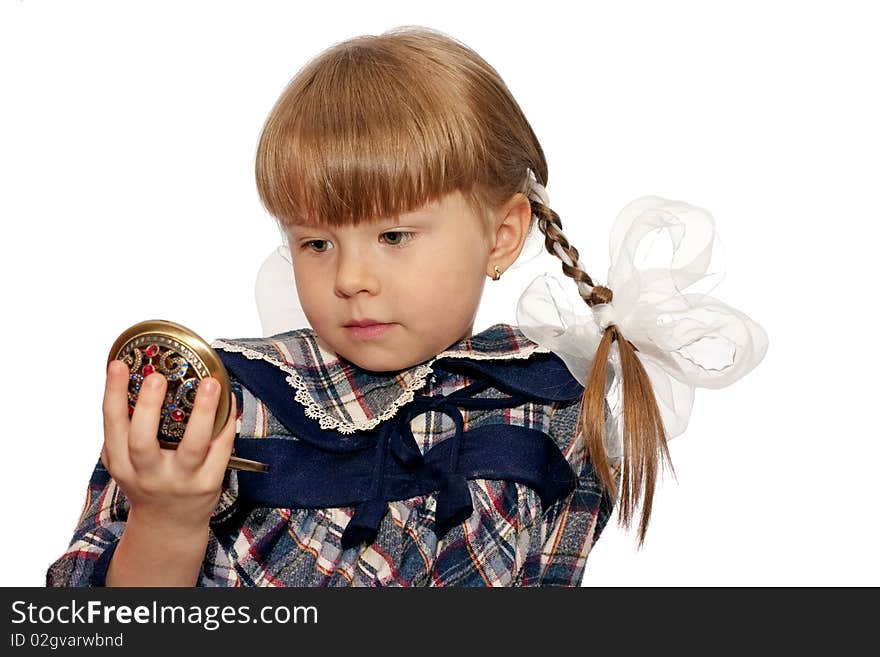 Little girl looks in pocket mirror isolated on white