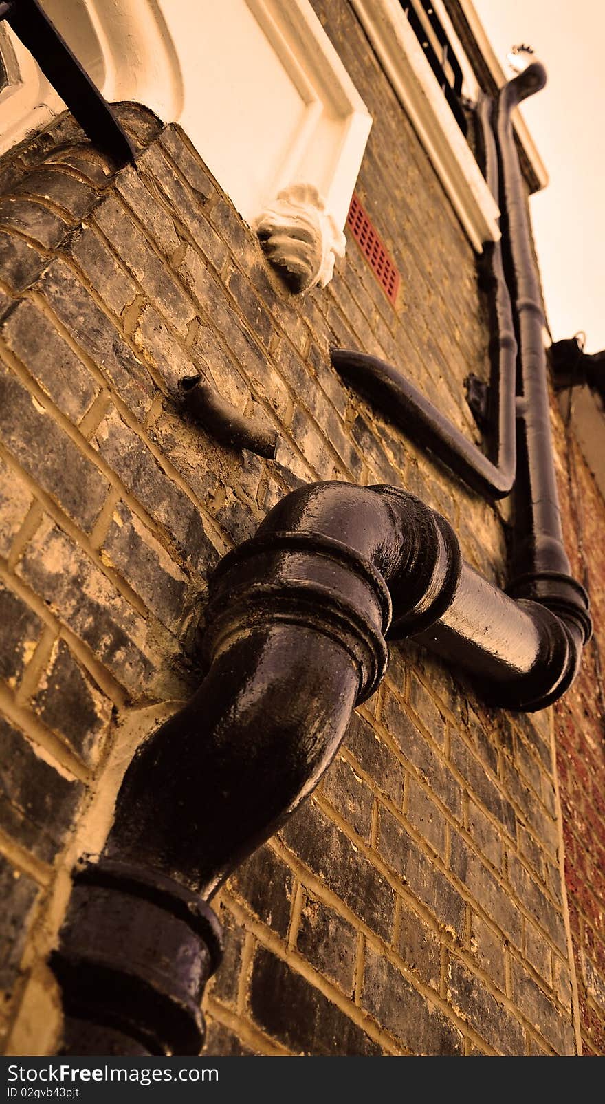 Plumbings hanging outside the house wall