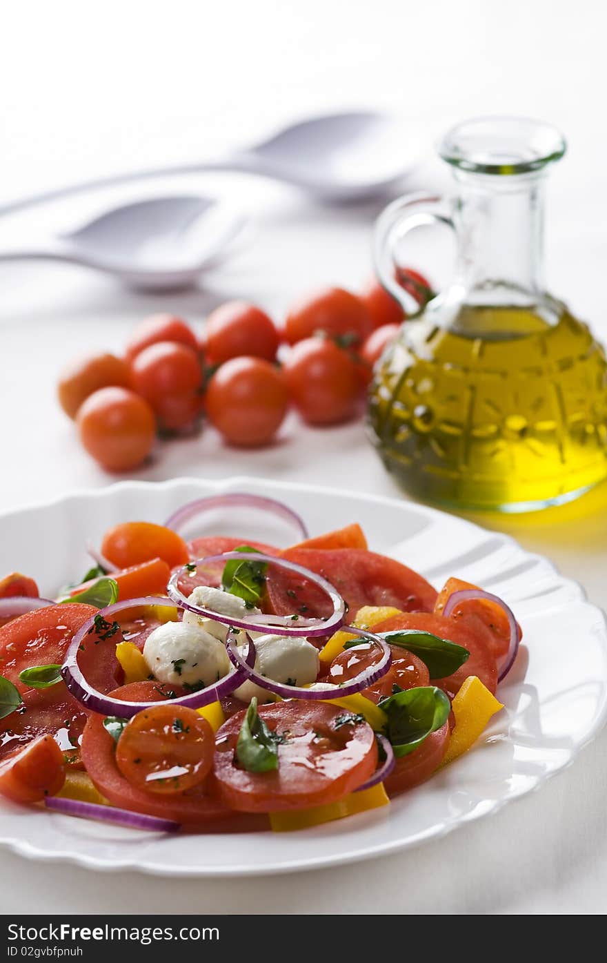 Sliced tomato and mozzarella with basil close up. Sliced tomato and mozzarella with basil close up