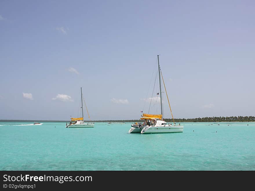 Catamarana and people swiming in caribbean sea