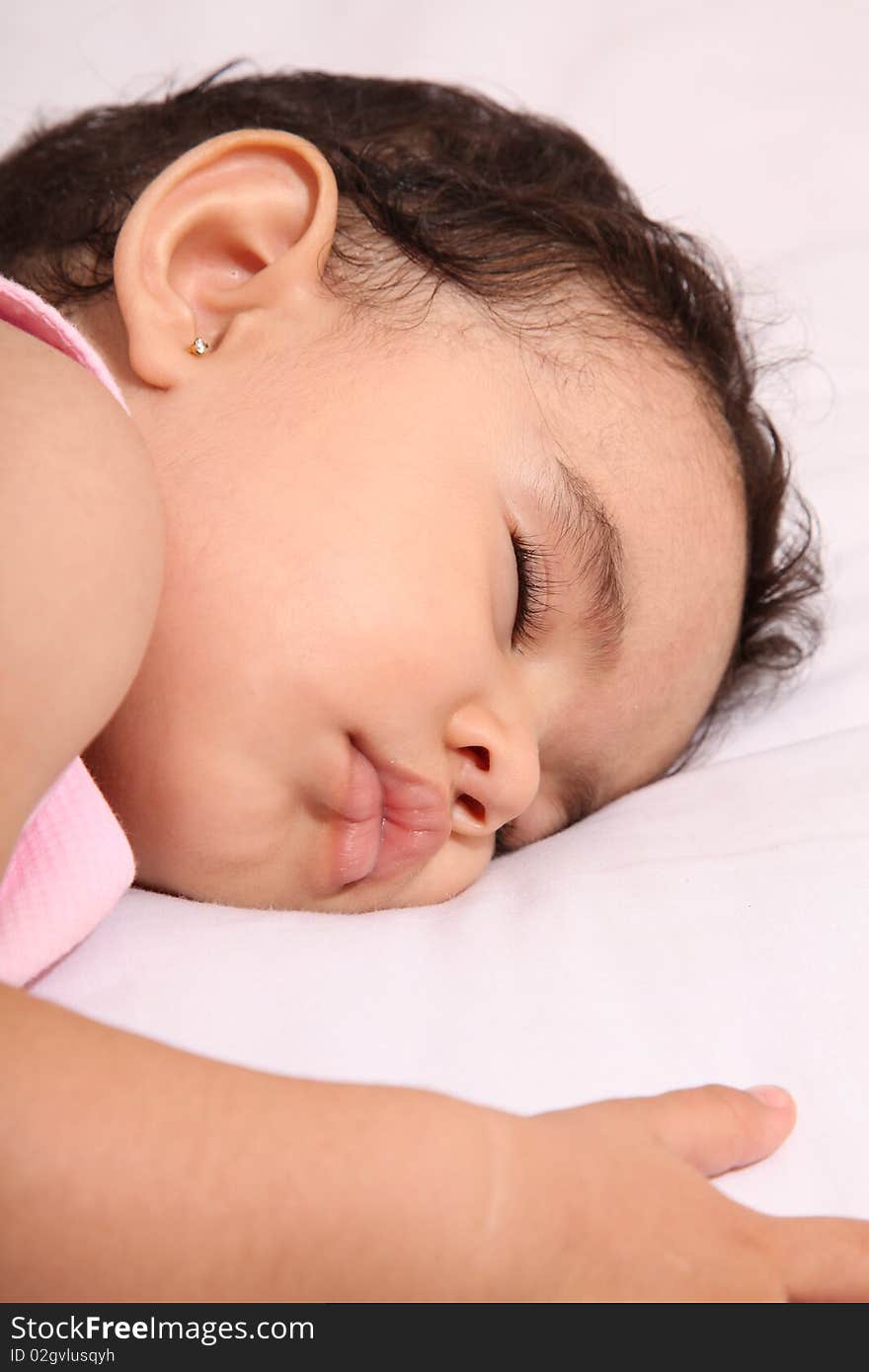 Baby sleeping on white blanket. one year old