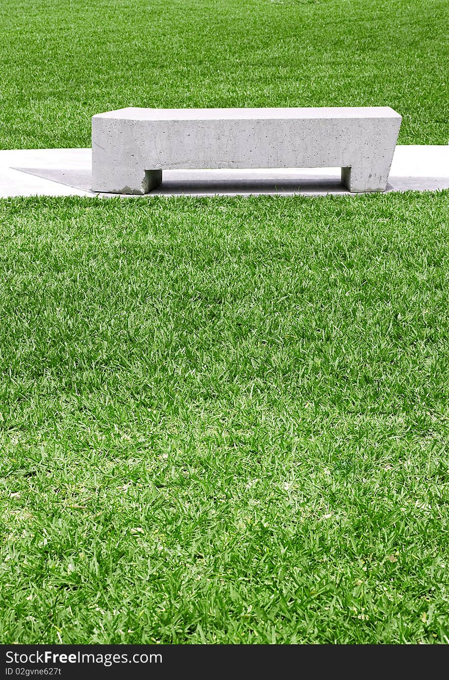 City park concrete benches on a beautiful sunny day with pristine green grass of the public park. City park concrete benches on a beautiful sunny day with pristine green grass of the public park