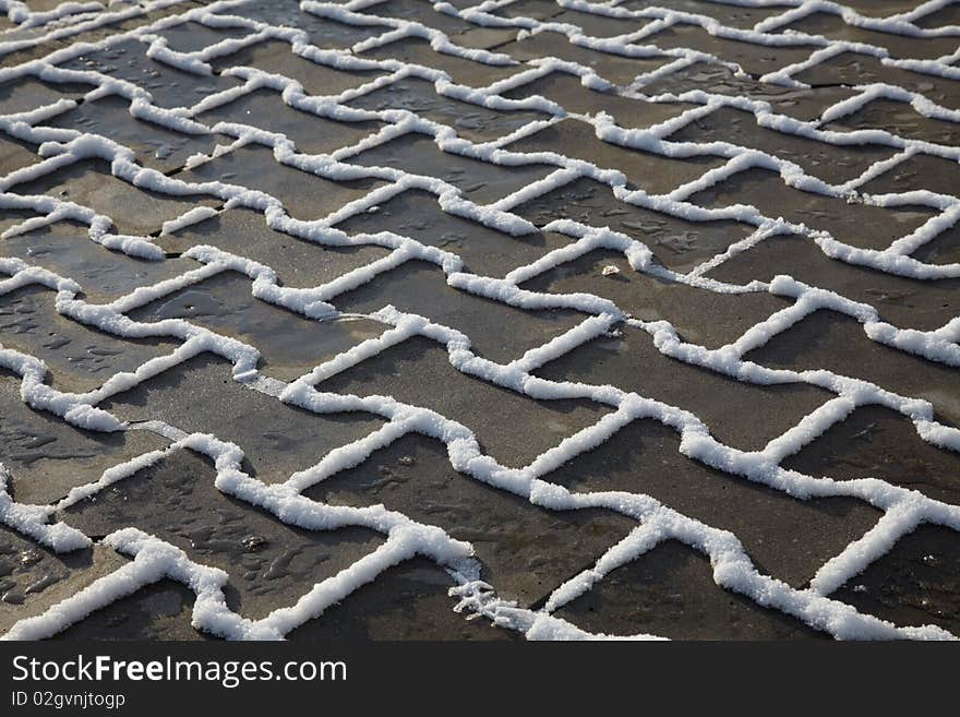 Snow and ice on paving flag at footpath