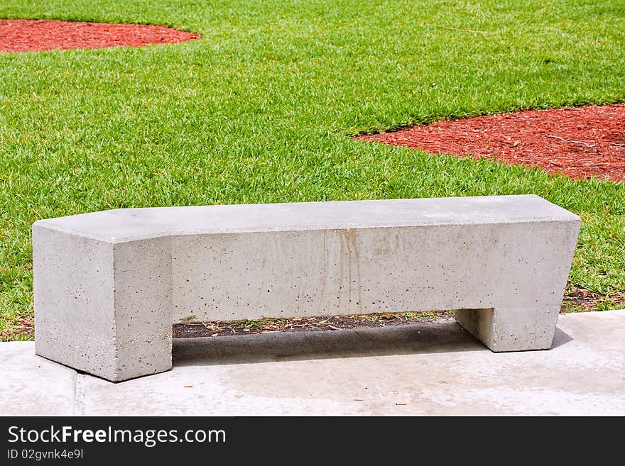 City park concrete benches on a beautiful sunny day with pristine green grass of the public park. City park concrete benches on a beautiful sunny day with pristine green grass of the public park