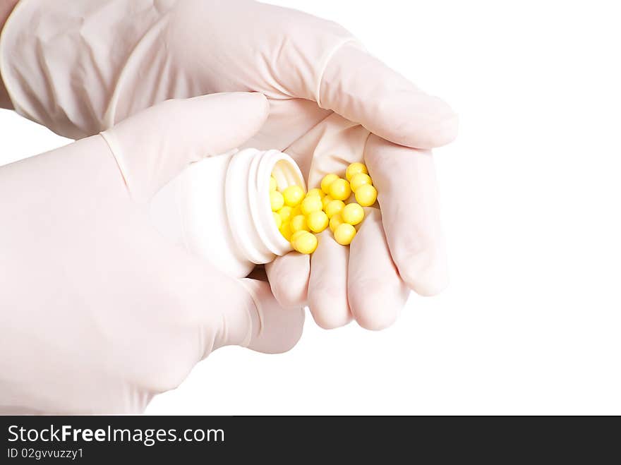 Female hands in rubber gloves holding medicines