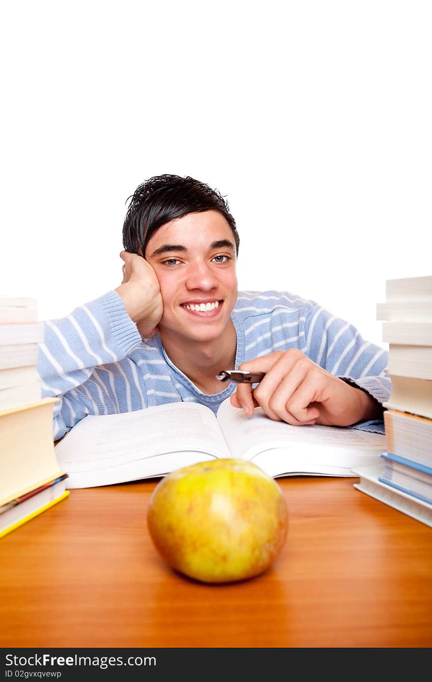 Young Smiling Male Student Learning Between Books