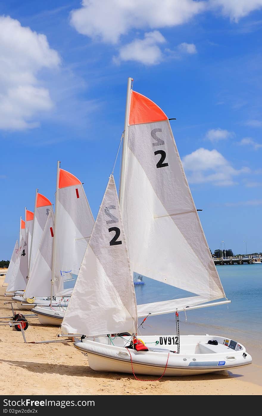 Several boats with sails standing in a row. as a symbol of teamwork in business