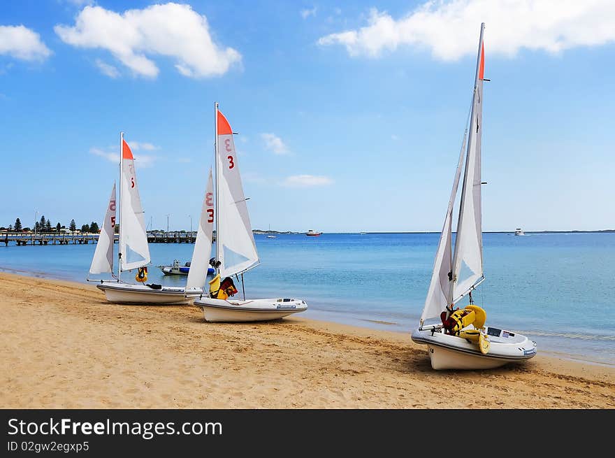 Several boats with sails standing in a row. as a symbol of teamwork in business