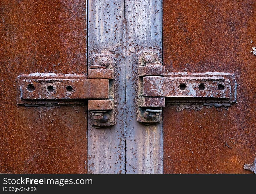 Old rusty metal hinge in the centre