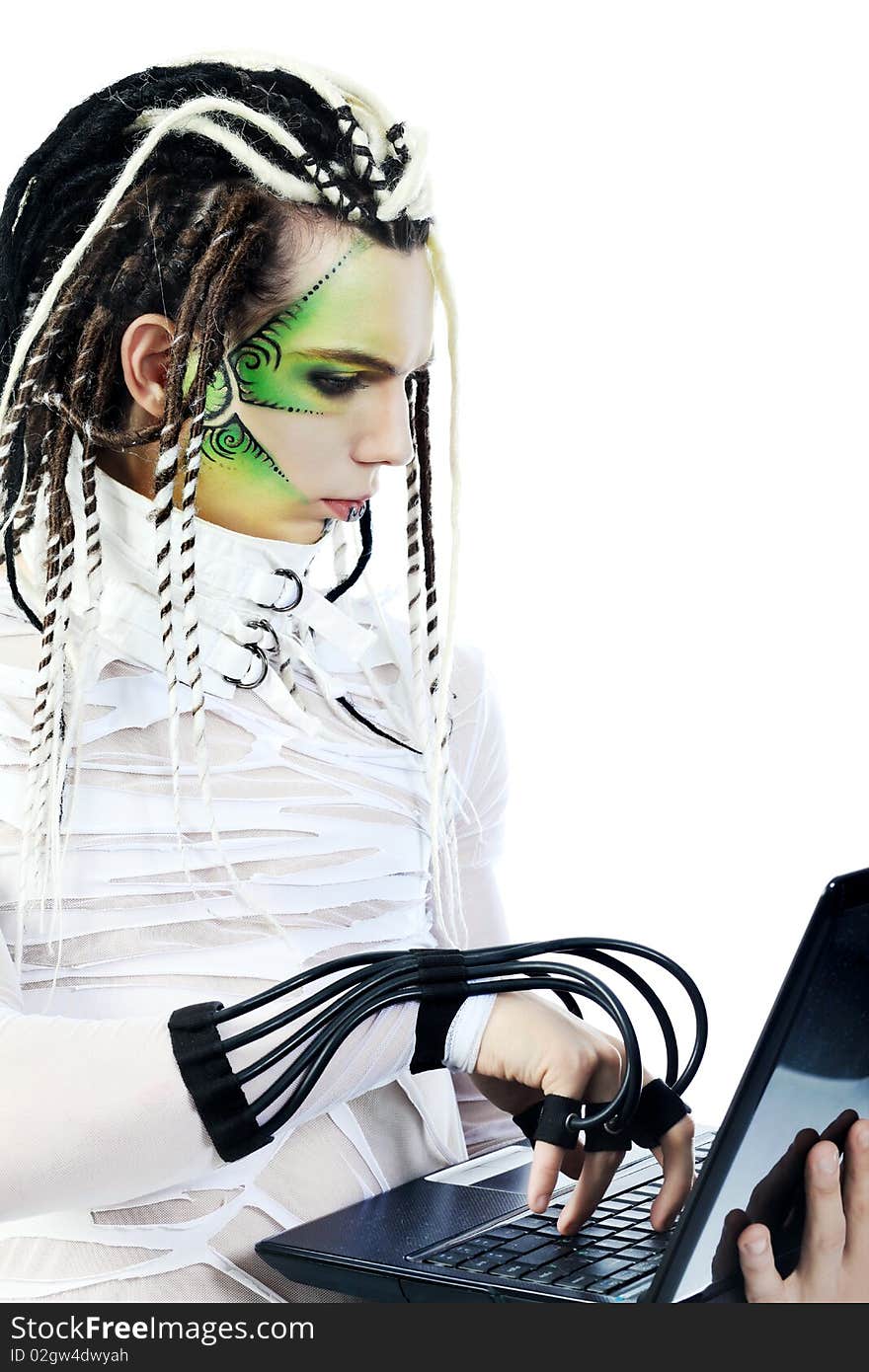 Shot of a futuristic young man with wires holding a laptop. Isolated over white background. Shot of a futuristic young man with wires holding a laptop. Isolated over white background.