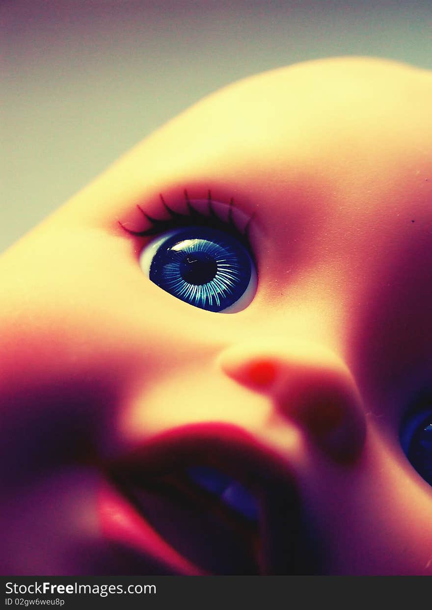 Close-cropped image of a child's doll toy with vintage effect. Close-cropped image of a child's doll toy with vintage effect