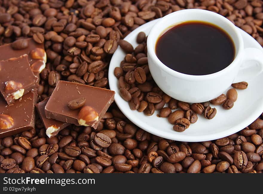 Cup of coffee on a background coffee grains