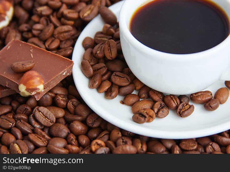 Cup of coffee on a background coffee grains