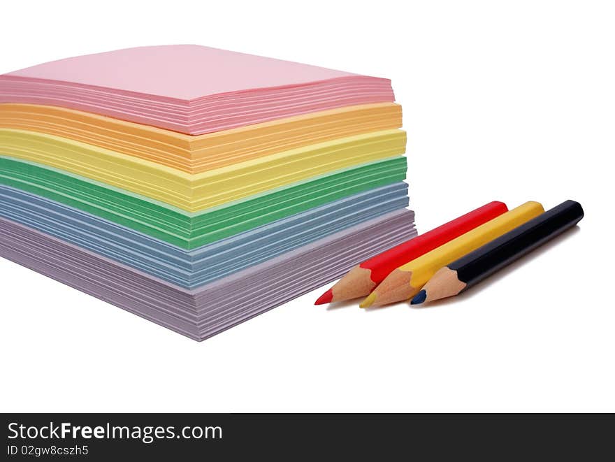 Colored paper for notes and three pencils. Colored paper for notes and three pencils