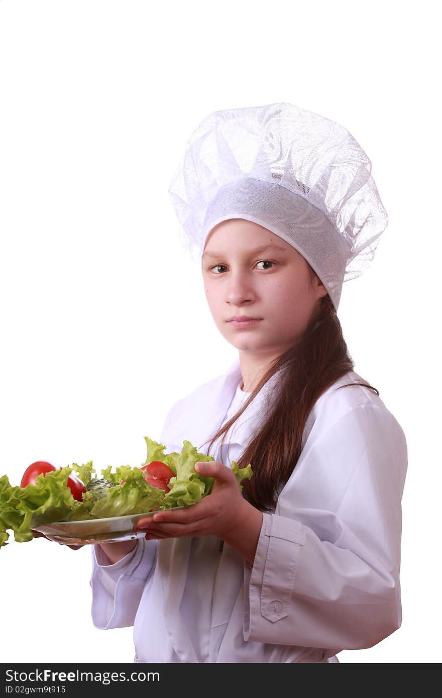 Portrait of teenager girl in chef uniform with vegetarian food. Isolated on white by lighting setup. Portrait of teenager girl in chef uniform with vegetarian food. Isolated on white by lighting setup