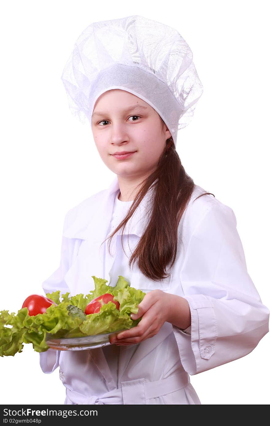 Portrait of teenager girl in chef uniform with vegetarian food. Isolated on white by lighting setup. Portrait of teenager girl in chef uniform with vegetarian food. Isolated on white by lighting setup